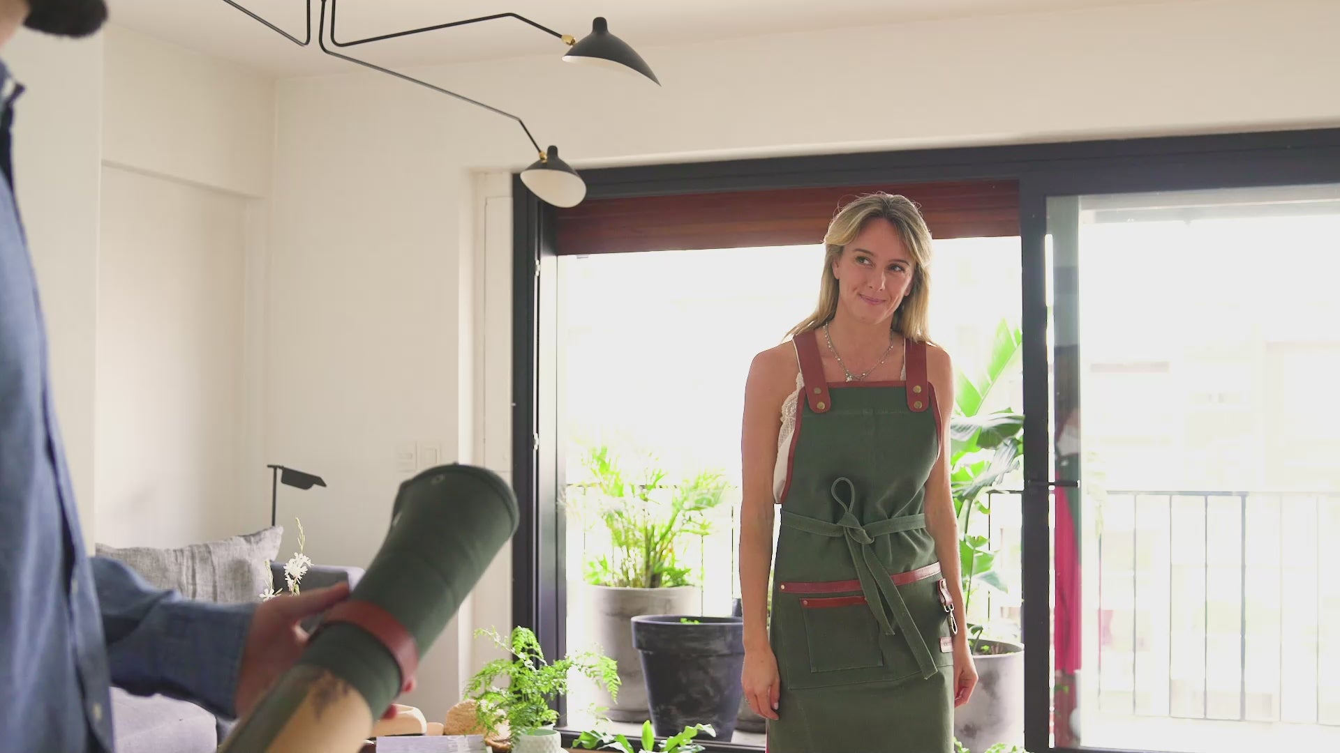 Video showcasing the Fleur Du Bien Plant Repotting Mat in action: folding and unfolding the waterproof waxed canvas, brass corner snaps and leather straps securing soil, indoor herbs and potted plants being repotted, keeping surfaces clean, spacious 30x30 and 30x20 inch sizes, reusable, eco-friendly, ideal for indoor gardening, herb gardens, DIY plant care, and mess-free planting.