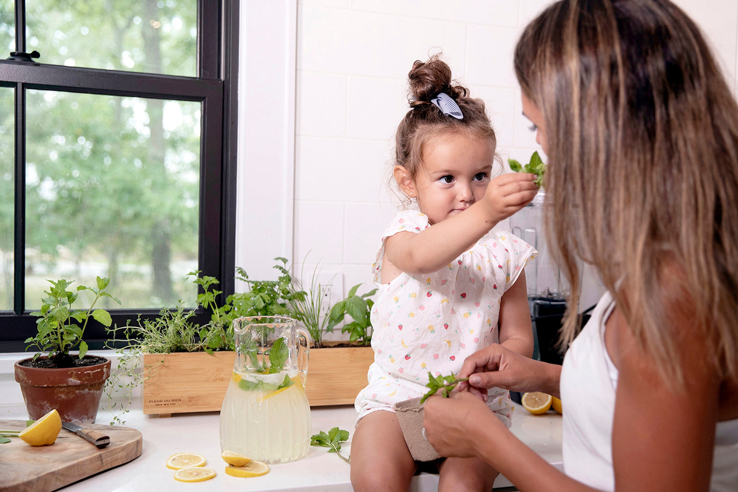Kids planting herbs in Fleur Du Bien Indoor Herb Garden Starter Kit with planter