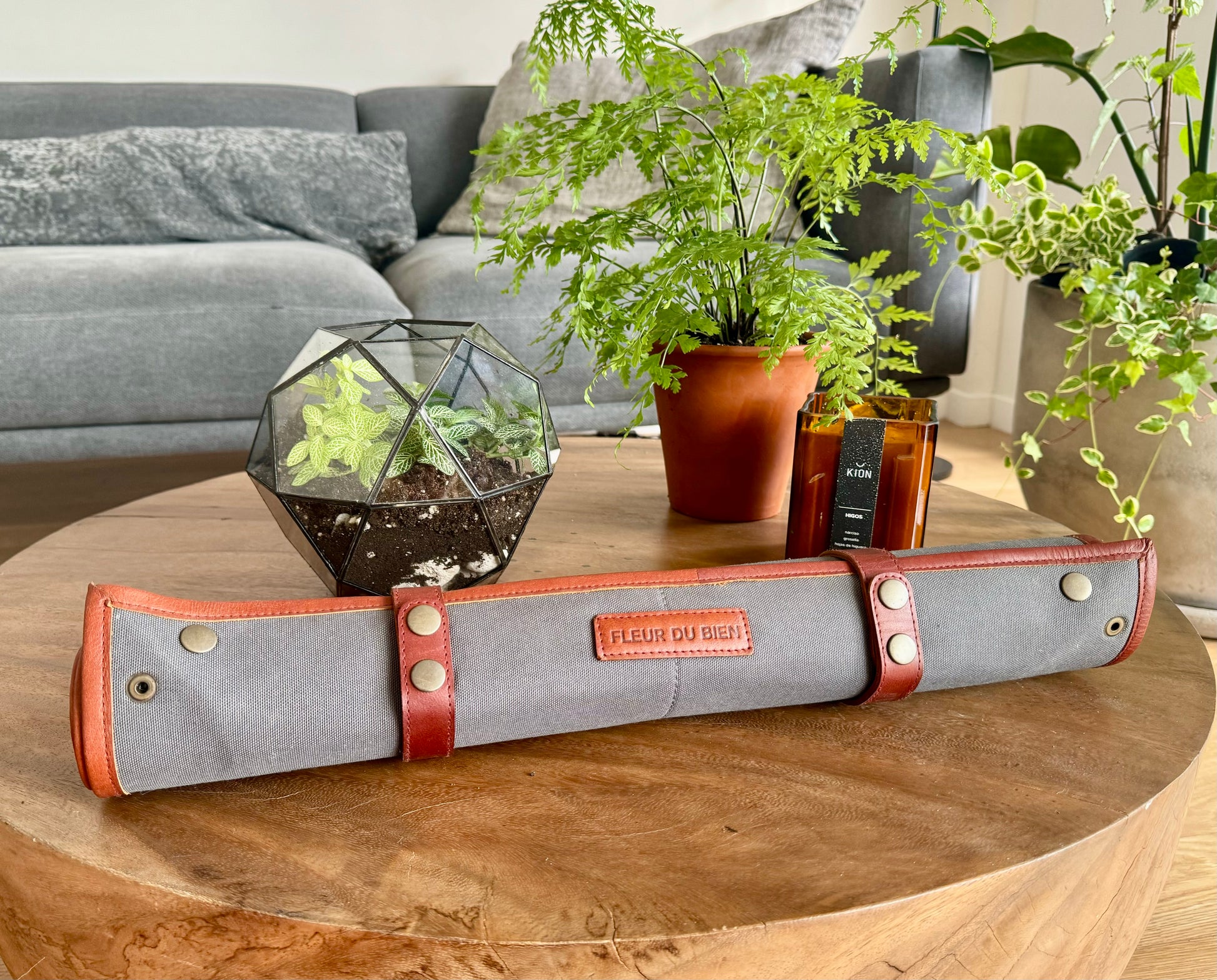 Fleur Du Bien 30x20 gray indoor repotting mat with leather trims, folded elegantly next to a terrarium on a solid rounded wooden table in a luxury minimalist home. Styled with a sustainable gardening book, perfect for indoor gardening, potting, transplanting, and eco-friendly DIY plant care. Combines elegance, durability, and mess-free gardening solutions.
succulent bonsai monstera ficus audrey plant indoor plant flower dried flower DIY home decor indoor garden herb garden 