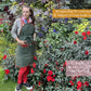 apron garden gardening garden hand tools outdoor garden
gardening accessories
plant repotting mat
gardening basket
gardening pots
Woman 1.62m tall wearing Fleur Du Bien apron in a luxury garden filled with red flowers and native plants, showing how the apron adjusts to her body type and complements her style