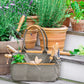 Fleur Du Bien 7-Piece Garden Tool Set – stainless steel tools with ergonomic wooden handles and canvas tote bag for indoor and outdoor gardening, eco-friendly and durable. A set of gardening tools with wooden handles including a spade, rake, trowel, transplanter, and cultivator, neatly placed inside a green canvas tote bag, displayed alongside potted plants.