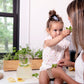 Kids planting herbs in Fleur Du Bien Indoor Herb Garden Starter Kit with planter